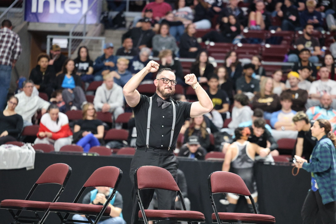 Coach Ahren Griego celebrating at a wrestling competition